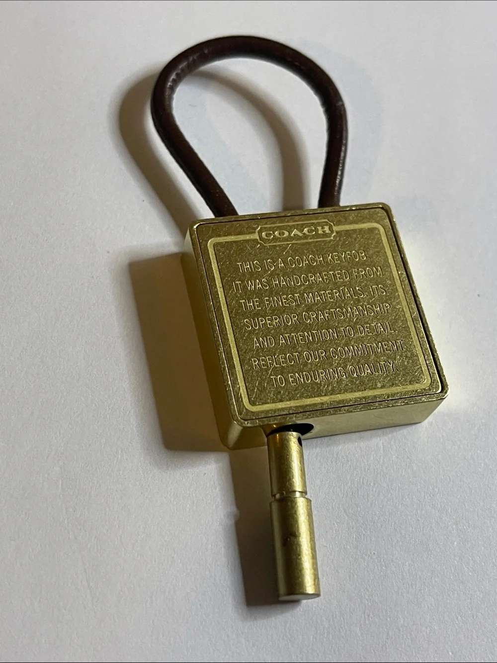 Coach Gold-Tone Brass Key Fob with Brown Leather Loop and Coach Pen